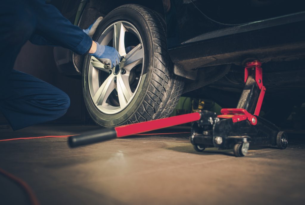 An image of a technician changing a tire.