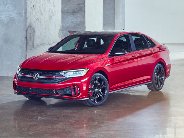 A red Volkswagen Jetta GLI sitting on a showroom floor. 