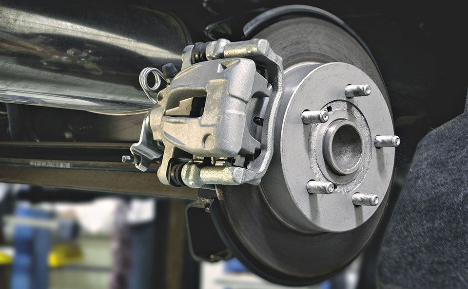 An image of a new set of brakes installed before the technician places the wheel back on the car. 