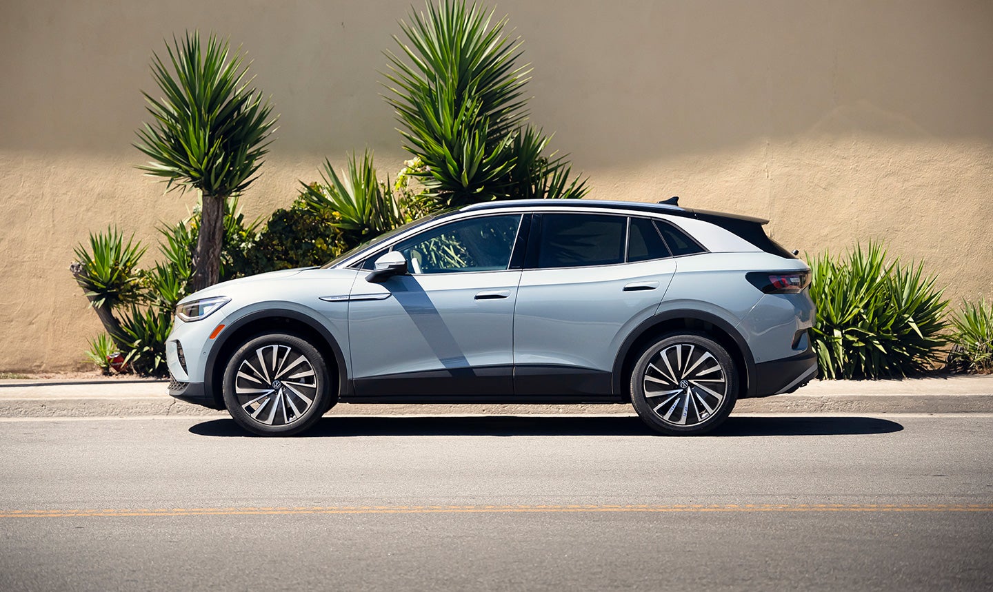 ID.4 AWD Pro S Plus shown in Arctic Blue Metallic parked next to a sidewalk.